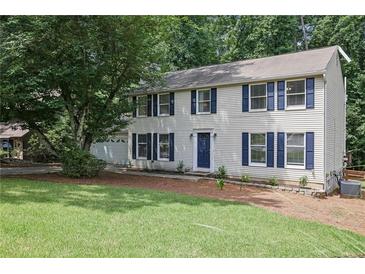 Two-story home with white siding, blue shutters, well-manicured lawn and mature trees at 9470 Hillside Dr, Roswell, GA 30076