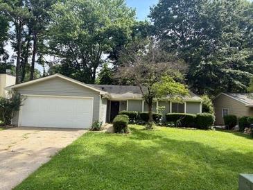 Charming single-story home with a well-manicured front lawn and mature trees at 10630 Worthington Hills Mnr, Roswell, GA 30076