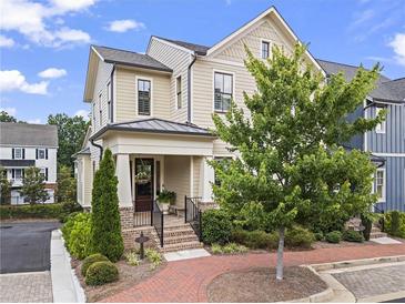 Charming two-story home with a welcoming front porch and beautifully landscaped yard at 205 Maplewood Dr, Roswell, GA 30075