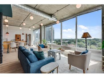 Bright living room with modern decor and large windows offering city views at 943 Peachtree Ne St # 814, Atlanta, GA 30309