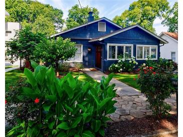 Charming blue home featuring a stone walkway, well-maintained landscaping, and inviting curb appeal at 1190 Francis Nw St, Atlanta, GA 30318