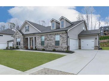 Charming single-Gathering home featuring a brick facade, attached garage, and well-maintained landscaping at 449 Carmichael Cir, Canton, GA 30115