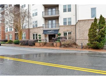 Apartment building exterior with awnings, professional landscaping, and manicured shrubbery at 901 Abernathy Ne Rd # 5140, Sandy Springs, GA 30328