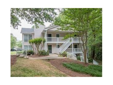 Exterior of a two-story home with stairs leading to the entrance with natural light and landscaping at 108 Countryside Se Pl, Smyrna, GA 30080