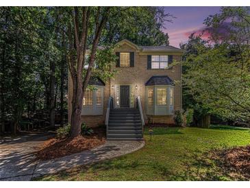 Charming two-story brick home with bay windows, fresh landscaping, and a welcoming staircase at 3440 Oaktree Way, Stonecrest, GA 30038
