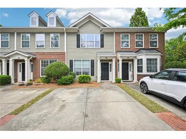 Charming townhome features well-maintained landscaping and private driveways at 2084 Del Lago Nw Cir # 1, Kennesaw, GA 30152