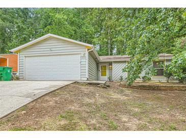 Charming single-story home with attached garage and driveway at 5273 Martins Crossing Rd, Stone Mountain, GA 30088