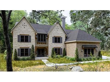 Stunning two-story home with a beautiful brick facade, dark shutters, and mature landscaping at 5743 Brendlynn Dr, Suwanee, GA 30024