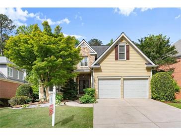 Charming two-story home with stone accents, lush landscaping, and a two-car garage at 4085 Tritt Homestead Dr, Marietta, GA 30062