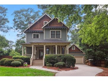 Charming two-story home with a covered front porch and beautifully landscaped front yard at 47 Oakridge Se Ave, Atlanta, GA 30317