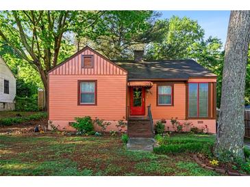 Charming single-story home with a landscaped front yard and colorful exterior at 1776 Fairway Hill Se Dr, Atlanta, GA 30317