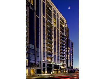 Elegant high-rise condo building featuring private balconies and modern architectural design against a twilight sky at 2425 Peachtree Ne Rd # 1505, Atlanta, GA 30305