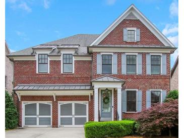 Charming two-story brick home with a two-car garage, manicured lawn, and inviting front entrance at 3467 Brookleigh Ne Ln, Atlanta, GA 30319
