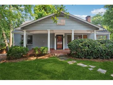 Charming home with a welcoming front porch, manicured lawn, and classic architectural details at 22 Peachtree Hills Ne Ave, Atlanta, GA 30305