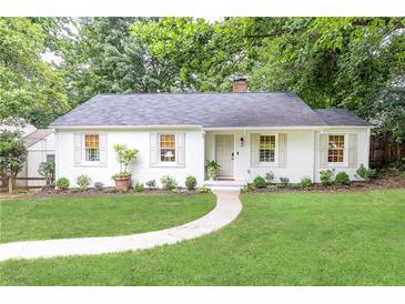 Charming, renovated one-story home with a manicured lawn and a welcoming walkway leading to the front door at 495 Hascall Nw Rd, Atlanta, GA 30309
