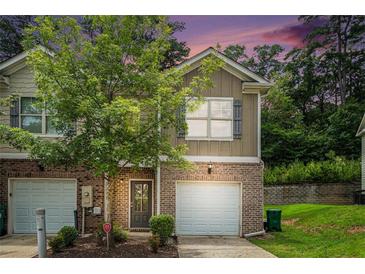 Charming townhome with brick accents, attached garage and inviting front yard at 3271 Pennington Dr, Stonecrest, GA 30038
