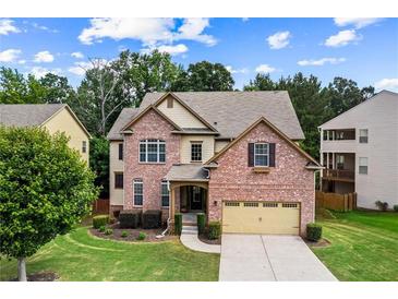 Charming two-story brick home with manicured lawn and attached two-car garage at 6175 Beaver Crossing Dr, Cumming, GA 30040