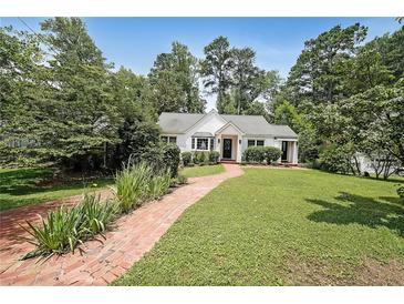 Charming single story home with manicured lawn and brick walkway at 167 Garden Ln, Decatur, GA 30030