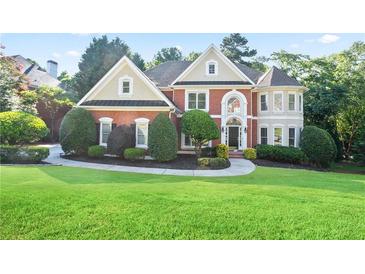 Beautiful two-story brick home with manicured lawn and landscaping, offering classic curb appeal at 3741 Cape York Trce, Alpharetta, GA 30022