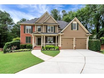 Charming two-story home featuring a manicured lawn, two-car garage, and inviting front porch at 28 Mcevers Branch Ct, Acworth, GA 30101