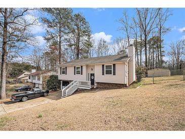 Charming home featuring a well-maintained lawn, inviting entryway, and classic architectural design at 6355 Queens Rd, Douglasville, GA 30135