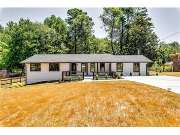 Charming renovated ranch-style home with white brick, dark trim, and a spacious front yard at 3122 Vandiver Dr, Marietta, GA 30066