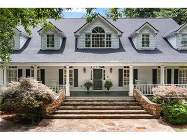 Charming two-story home featuring a welcoming front porch and stone staircase at 1824 Mount Paran Nw Rd, Atlanta, GA 30327