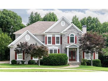 Charming two-story home with stone accents, red shutters, and lush landscaping at 2693 Blairsden Nw Pl, Kennesaw, GA 30144