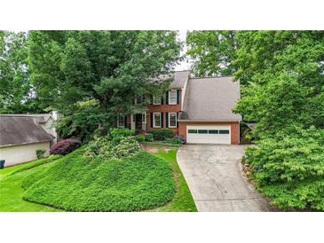 Charming two-story brick home with lush landscaping and a long driveway at 4313 Deep Springs Nw Ct, Kennesaw, GA 30144