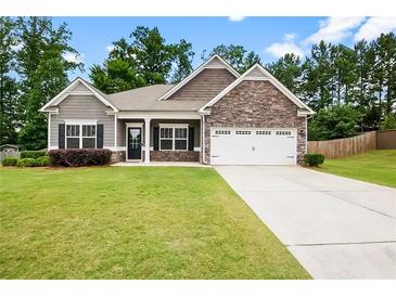 Charming single-Gathering home featuring a well-manicured lawn and inviting front entrance at 132 Berkleigh Trails Dr, Hiram, GA 30141