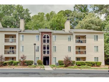 Attractive apartment building offering balconies, mature trees, and convenient parking at 591 Emory Oaks Way # 591, Decatur, GA 30033