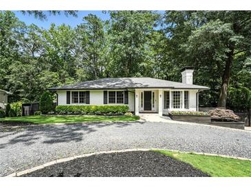 Charming home with a white exterior, a manicured lawn, and mature trees at 2676 Cottonwood Dr, Marietta, GA 30066