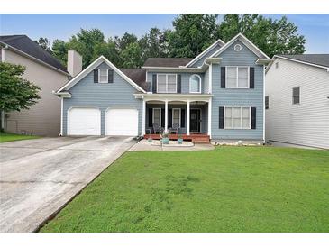 Charming two-story home featuring a well-manicured lawn, a two-car garage, and a welcoming front porch at 4321 Clairesbrook Ln, Acworth, GA 30101
