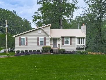 Charming home featuring green lawn, landscaped garden beds and lovely neutral siding and brick accents at 629 Silver Trace Ct, Woodstock, GA 30189