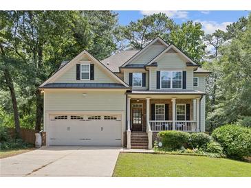 Charming two-story home with a two-car garage, landscaped yard, and inviting front porch perfect for relaxing at 3541 Wilton Ave, Atlanta, GA 30340