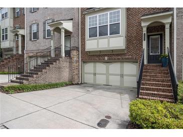 Charming townhomes with brick facade, attached garages, and inviting staircases at 1935 Cobblestone Ne Cir, Brookhaven, GA 30319