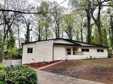 Charming single-story home with a brick exterior, updated landscaping, and a welcoming front porch at 2544 Overlook Dr, Atlanta, GA 30344
