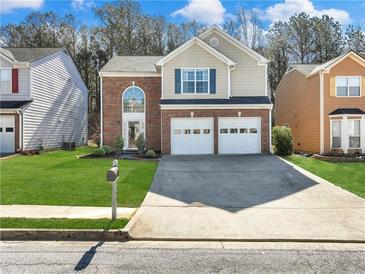 Charming two-story home with brick accents, well-manicured lawn, and a two-car garage at 2304 Stancrest Ln, Lawrenceville, GA 30044