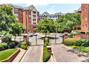 Beautiful exterior view of the luxurious condo building with manicured landscaping and gated entrance at 211 Colonial Homes Nw Dr # 1102, Atlanta, GA 30309