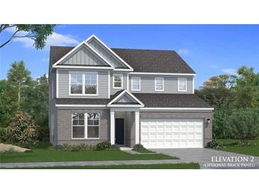 Charming two-story home with brick and gray siding, complemented by a well-manicured lawn at 271 Abbotts Crossing Cir, Conyers, GA 30094