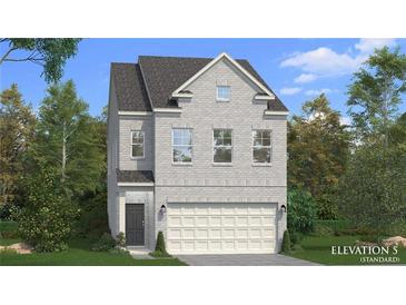 New two-story home design featuring light brick, attached garage, and manicured landscaping at 267 Abbotts Crossing Cir, Conyers, GA 30094
