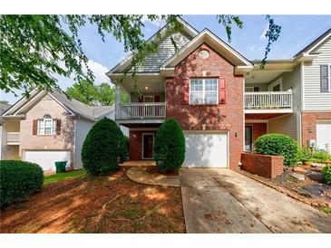 Charming two-story brick and siding home with a balcony and manicured landscaping at 1830 Broadway St, Decatur, GA 30035