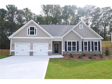 Charming one-story home featuring a two-car garage and well-manicured lawn at 14 Berkten Ct, Hiram, GA 30141