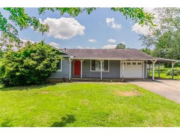 Charming single-story home with a well-maintained lawn and covered parking at 3217 Canterbury Trl, Rex, GA 30273