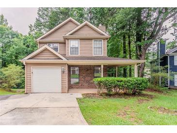 Charming two-story home with a covered front porch and a well-maintained lawn at 5073 Leland Dr, Stone Mountain, GA 30083