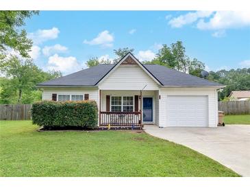 Charming single-story home featuring a well-manicured lawn and an attached one car garage at 15 Echota Ne Rd, Cartersville, GA 30121