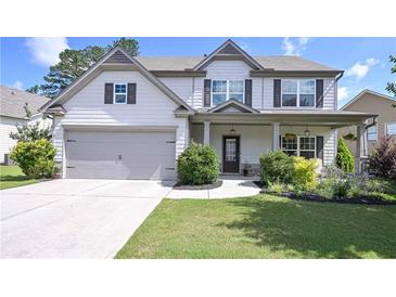 Charming two-story home with manicured lawn, two car garage, and inviting front porch at 110 Serendipity Way, Dallas, GA 30157