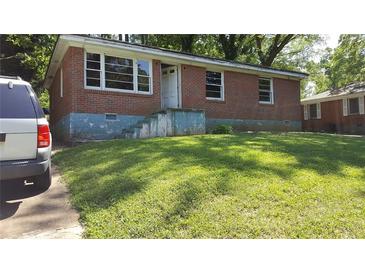 Charming single-story brick home with a well-maintained front yard, offering classic curb appeal at 2545 Saint Patrick Se St, Atlanta, GA 30317