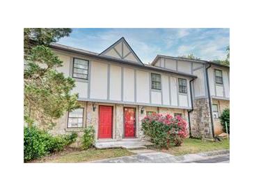 Charming townhome with stone accents, red doors, and beautiful landscaping at , Stone Mountain, GA 30083
