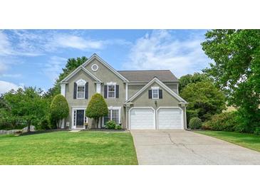 Charming two-story home with a well-manicured lawn and a two-car garage at 3635 Bardfield Ct, Cumming, GA 30041